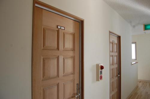 una puerta de madera en una habitación con pasillo en Minshuku Namisou, en Iriomote