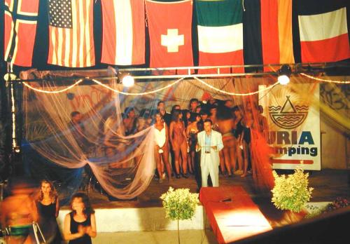 a group of people on a stage with flags at Villaggio Camping Uria in Foce Varano