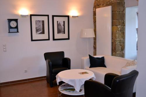 a living room with a couch and chairs and a table at Hotel Grazerhof in Bad Gleichenberg