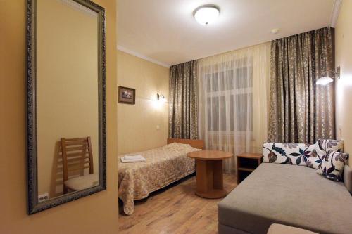 a hotel room with a bed and a mirror at Raze in Palanga