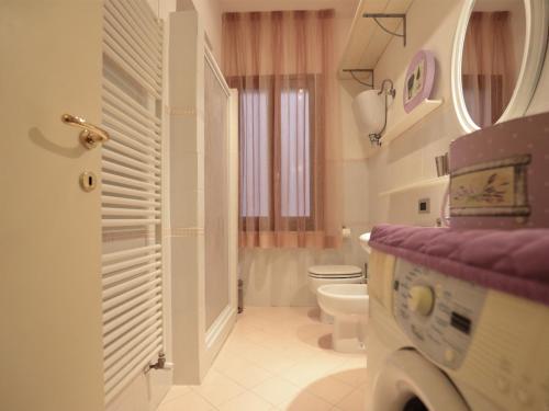 a white bathroom with a toilet and a sink at Residenza Raffaello in Foligno