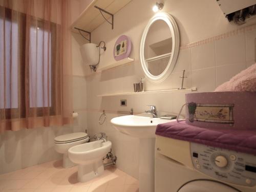 a bathroom with a sink and a toilet and a mirror at Residenza Raffaello in Foligno