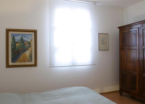 a bedroom with a bed and a picture on the wall at Il Borghetto in Cavriago