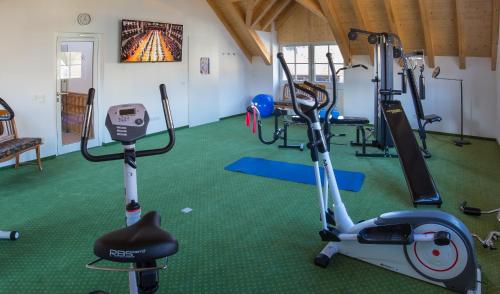 a gym with exercise bikes and a treadmill at Lahntalhotel Feudingen in Bad Laasphe
