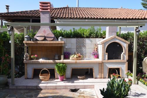 a model of a house with a fireplace in a backyard at House with Big Garden in Korinthos