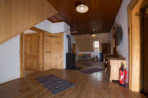 a living room with wooden floors and wooden ceilings at Die Traunmühle in Bad Aussee