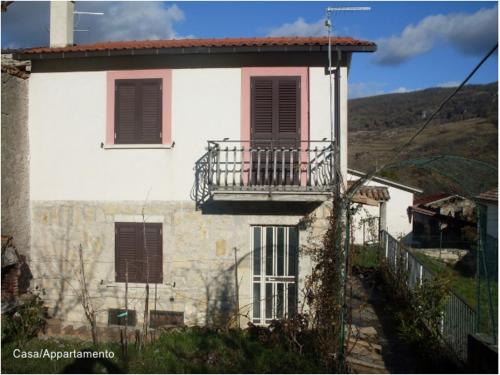 a white house with a balcony on the side of it at Casa Vacanze Le Vigne in Rionero Sannitico