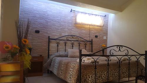 a bedroom with a bed and a brick wall at La Casa Dei Sogni in Gallico