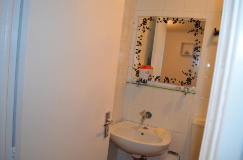 a bathroom with a sink and a mirror at Apartamento Piquinho in Machico