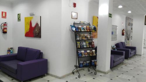 a waiting room with purple couches in a hospital at Kristal in Torremolinos