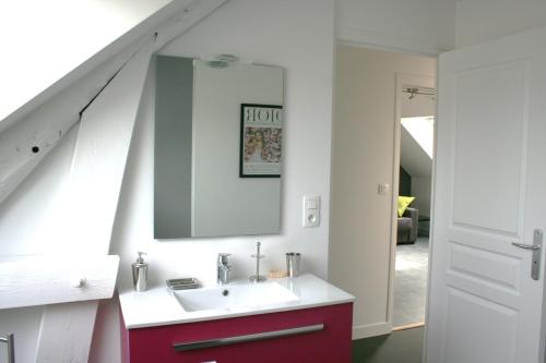 a bathroom with a sink and a mirror at La Cattevillaise in Saint-Pair-sur-Mer