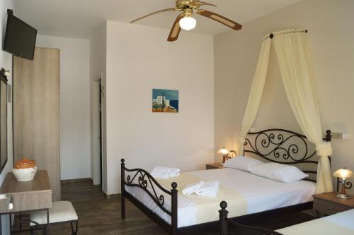 a bedroom with a bed and a television in it at Margarita Karidi in Apollonia