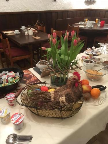 a table with a chicken in a basket of fruit at Al Boccalino Bed&Breakfast in Melide