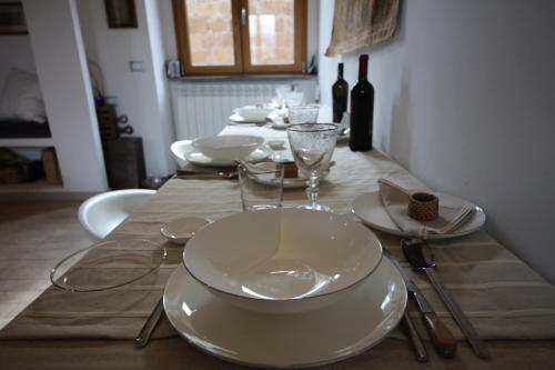 a table with white plates and glasses on it at Nerone's - Sutri Bed & Dinner in Sutri