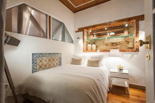 a bedroom with a white bed and a window at Bairro Alto Lusitania Dream in Lisbon