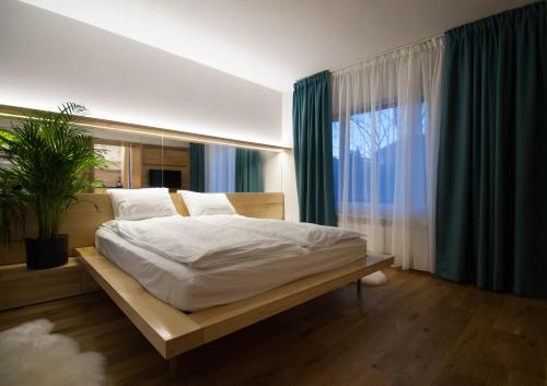 a bedroom with a bed and a large window at Garden House in Timişoara
