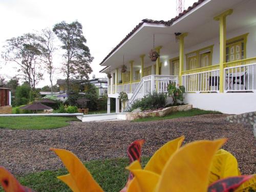 a house with a yellow and white at Hotel Salento Plaza in Salento