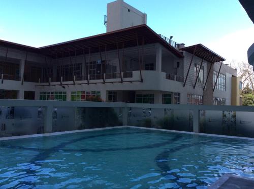 an empty swimming pool in front of a building at Mary's Crib Cityland Prime Tagaytay with Free Wifi & Swimming in Tagaytay