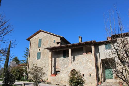 a large stone building with a blue sky in the background at Fattoria di Rigone in Coltavolino