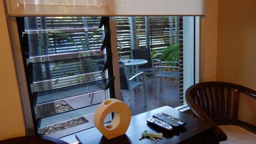 a view of a room with a table and a window at Bali Studio in Darwin