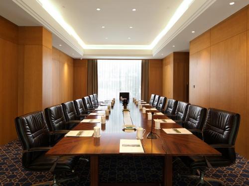 a large conference room with a long table and chairs at Xiamen C&D Hotel-Free Welcome Snacks-Oasis Garden in Xiamen