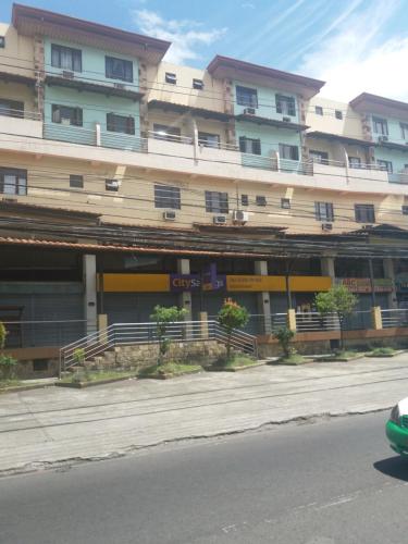 a large building on the side of a street at 722 Metropolis Tower Unit 212 in Bacolod