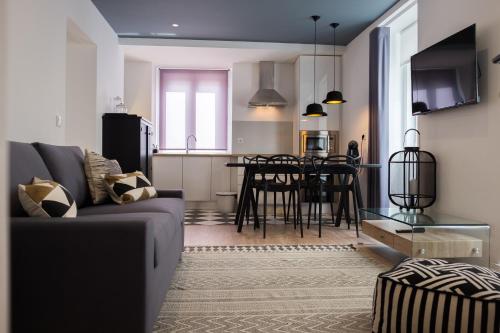 a living room and kitchen with a couch and a table at Ocean Center Apartments in Cascais