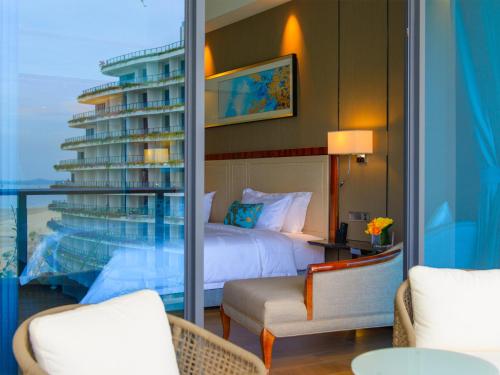 a hotel room with a bed and a balcony at Forest City Marina Hotel in Nusajaya