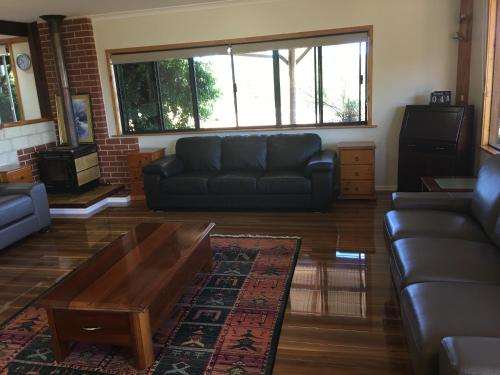 a living room with a couch and a coffee table at Jarrah Glen Cabins in Nannup