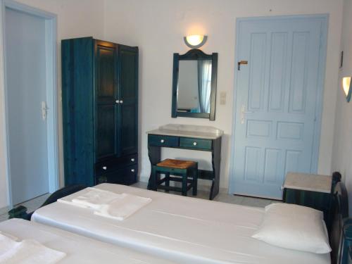 a bedroom with a bed and a dresser and a mirror at Blue & Sea Studios Apartments in Drios