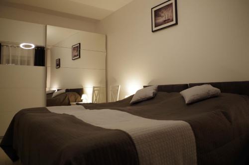 a bedroom with a large bed with two pillows on it at Apartament Żarko in Pogorzelica