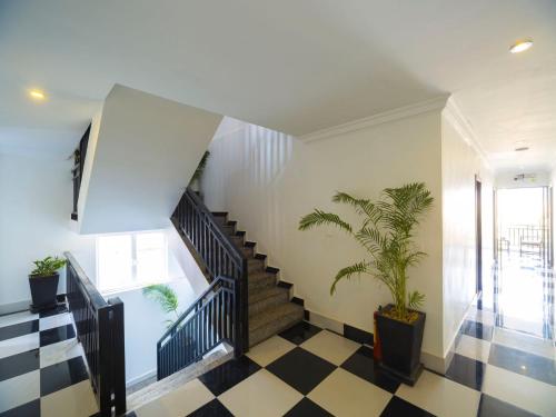 a hallway with stairs and a potted plant at Rithy Rine Angkor Residence in Siem Reap