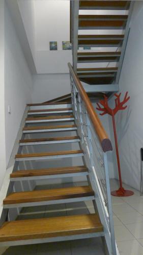a set of stairs in a room with a painting at Wesberly Apartments in Kuching