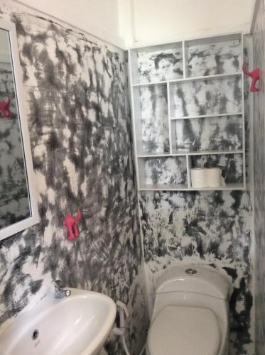 a bathroom with a toilet and a sink at The Patio Yogya in Yogyakarta