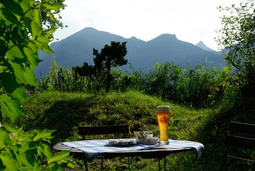a picnic table with a glass of beer on it at Gasthof Zum Ott in Staudach-Egerndach