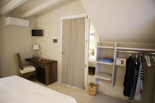 a bedroom with a bed and a desk and a closet at Avion B&B in Cagliari