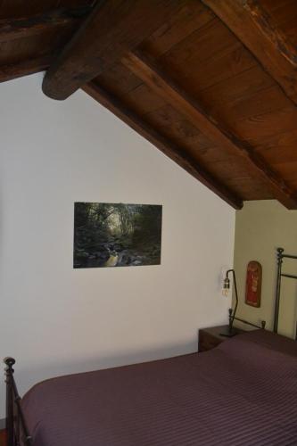 a bedroom with a bed and a painting on the wall at Casa Martino in Villa