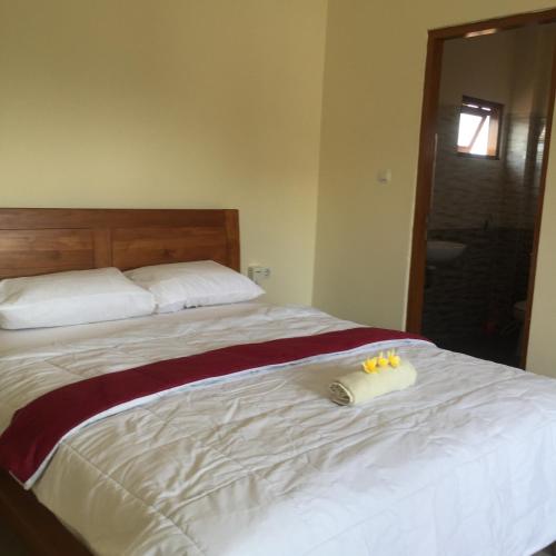 a bedroom with a bed with two towels on it at Bagus Homestay in Ubud