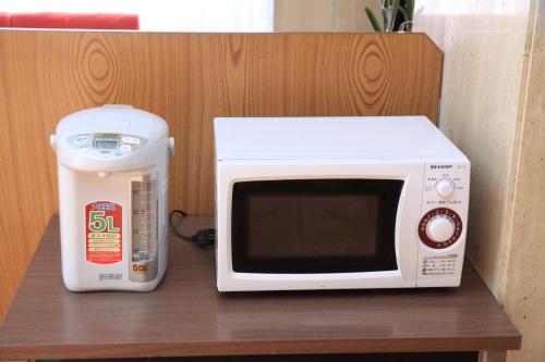 a counter with a microwave and a mixer on a table at Toyokawa Grand Hotel in Toyokawa