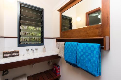 a bathroom with a sink and a mirror at The Courthouse Bed & Breakfast in Broome