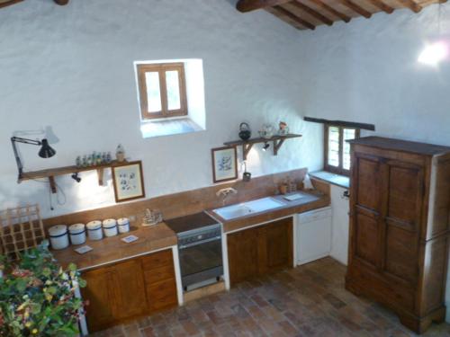 a kitchen with a sink and a stove top oven at Della Genga Resort in Arezzola