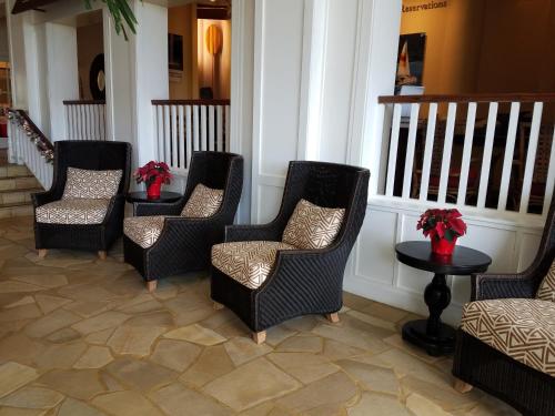 a group of chairs and tables with flowers on them at 2417 at Oceanfront Resort Lihue Kauai Beach Drive Private Condo in Lihue