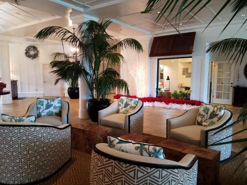 a lobby with chairs and a table and palm trees at 2417 at Oceanfront Resort Lihue Kauai Beach Drive Private Condo in Lihue