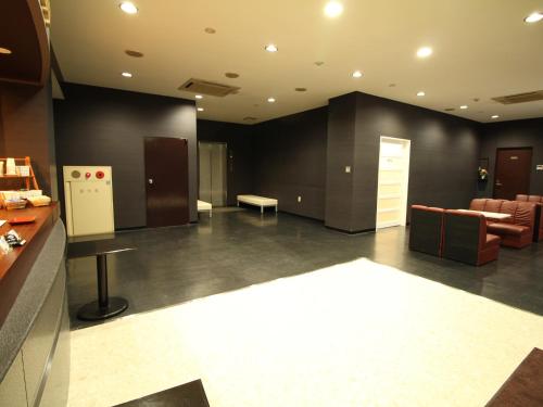 a large room with a couch and a table in a room at Hotel LC Gifu Hashima in Hashima