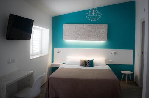 una camera con letto e parete blu di I MURETTI A SECCO B&B a Castel del Monte