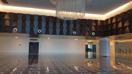 a large hall with a chandelier and a floor at Zen Studio @ Trefoil Setia Alam in Shah Alam