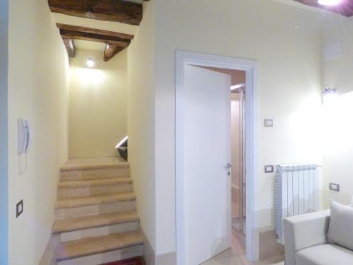 a hallway with a staircase in a house at Ca' Neldo - VeniseJeTAime in Venice