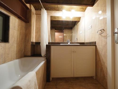 a bathroom with a bath tub and a sink at Paseo de Gracia Design in Barcelona