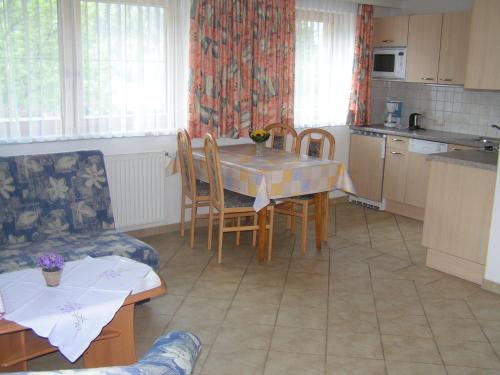 a kitchen with a table and chairs and a table and a kitchen at Alpenview Lechtal in Holzgau