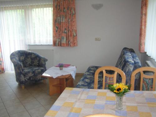 a living room with a table and two chairs and a table and a table at Alpenview Lechtal in Holzgau